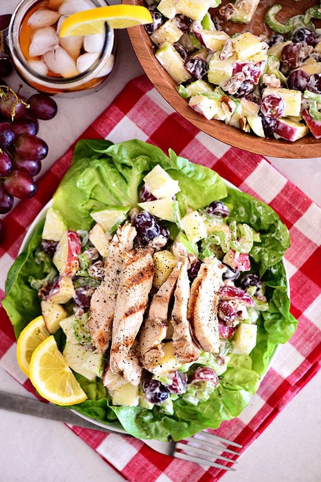 Chicken Waldorf salad on a plate with a glass of ice tea