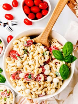 Caprese Macaroni Salad with fresh tomatoes in a serving bowl