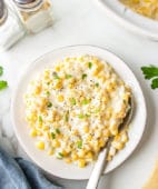 Easy Cream Cheese Corn on a plate and by a slow cooker