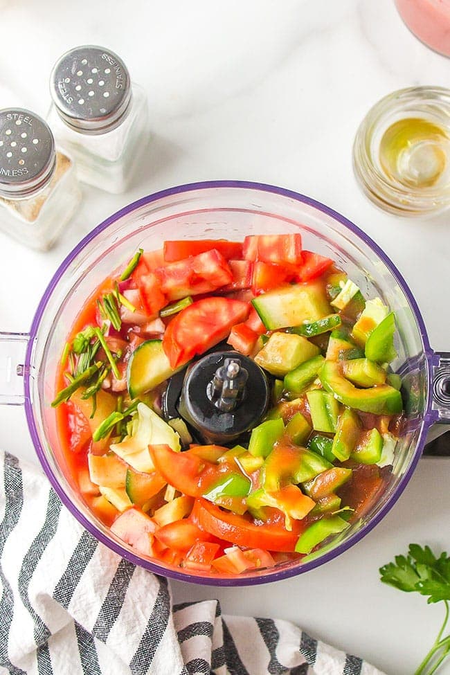 fresh summer veggies in a food processor for gazpacho