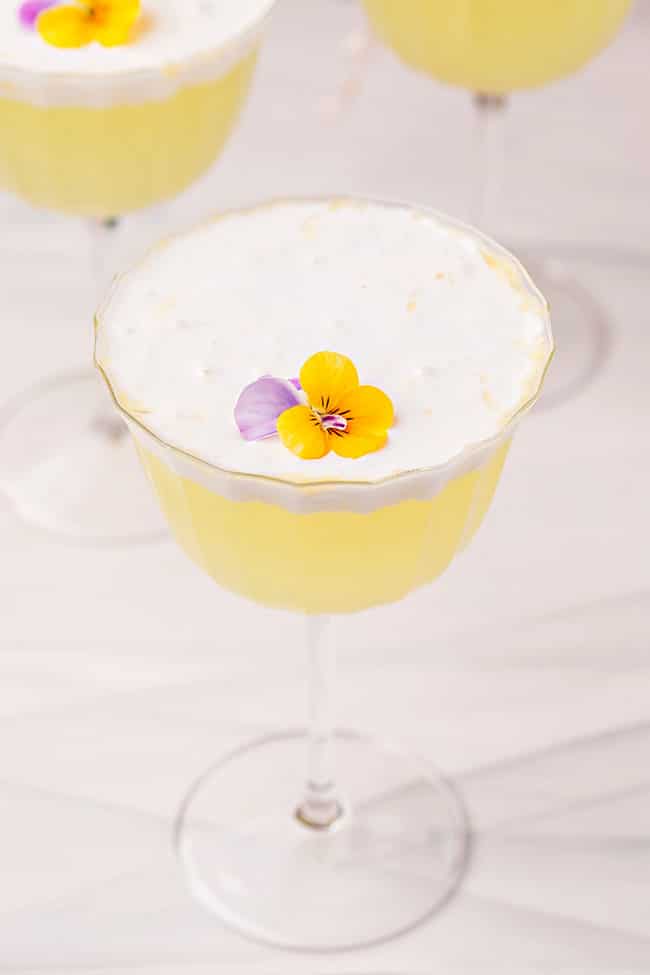 Lemon dessert cocktail with edible flowers