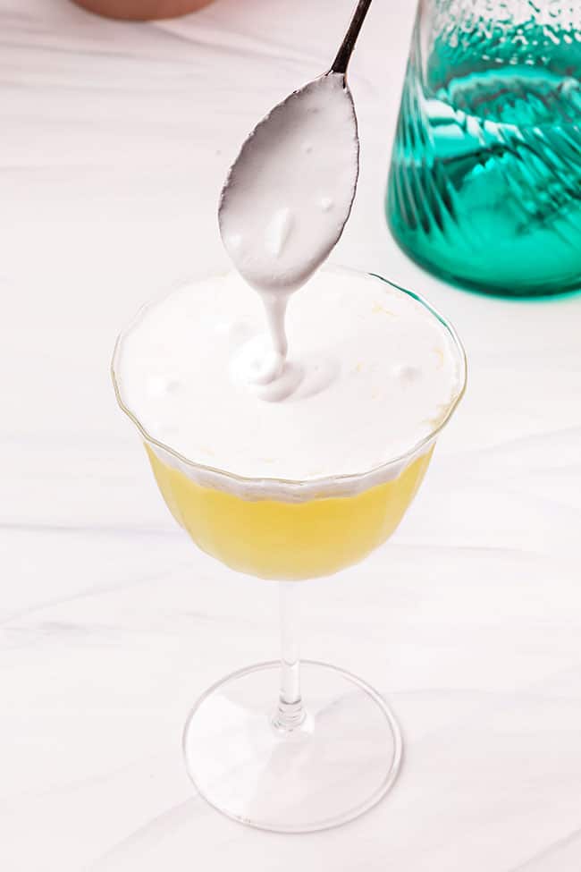 pouring meringue on a lemon dessert martini