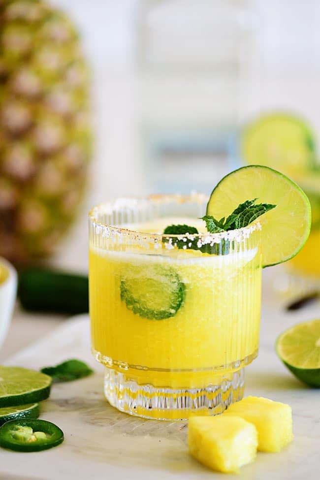 Glass of pineapple margarita with fresh pineapple