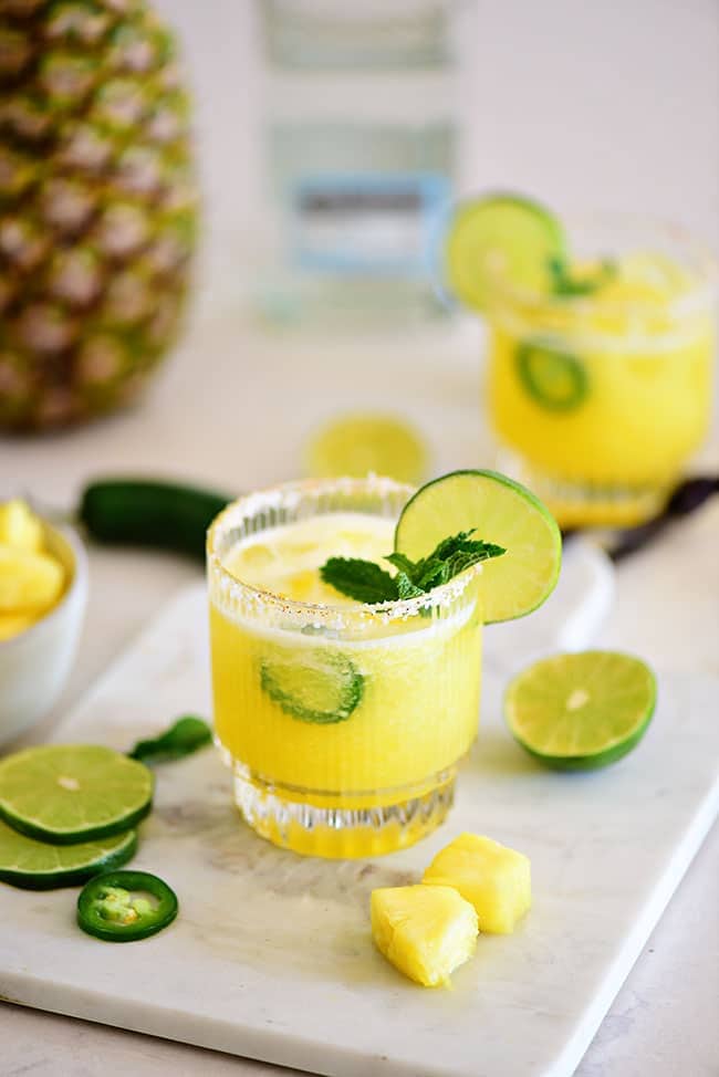 summer cocktail in a glass with mint, fresh lime and jalapeño slices