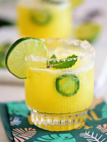 Pineapple Jalapeño Margarita in a glass with lime slice granish