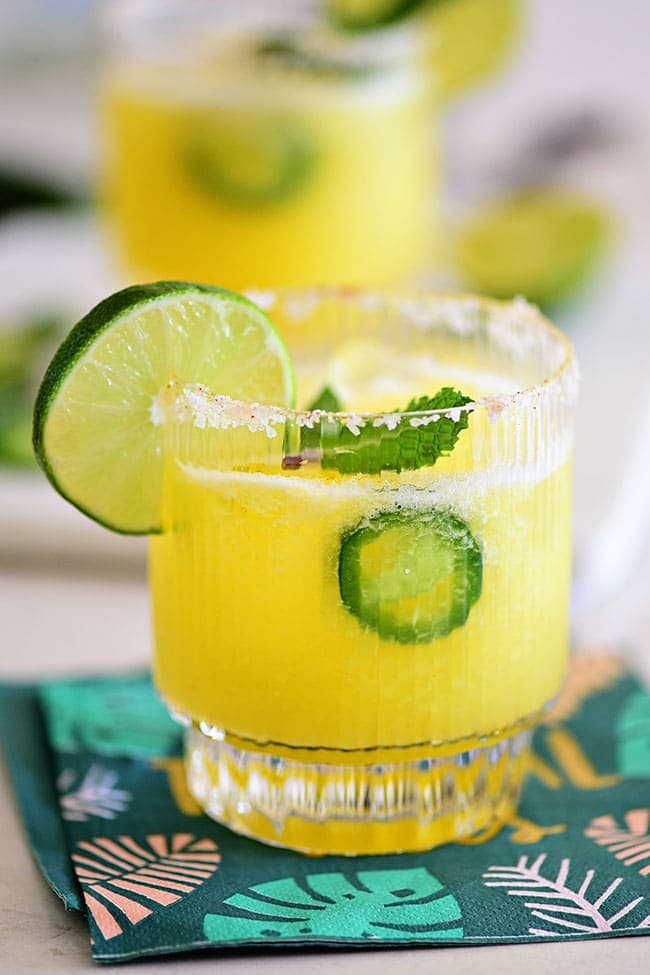 Pineapple Jalapeño Margarita in a glass with lime slice granish
