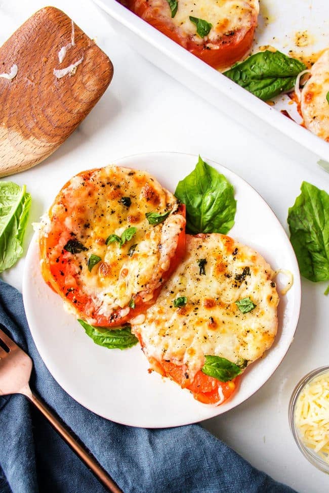 Oven baked tomatoes with cheese on a plate