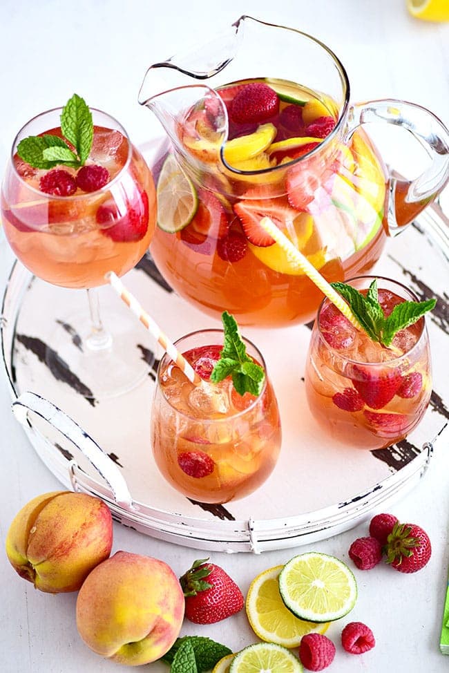 White sangria with peaches and Rosé served on a round white tray