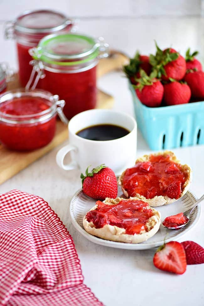 No-cook Strawberry Freezer Jam spread on an English muffin with a cup of coffee