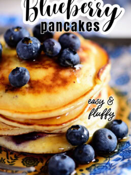 a stack of buttermilk pancakes with fresh sweet blueberries