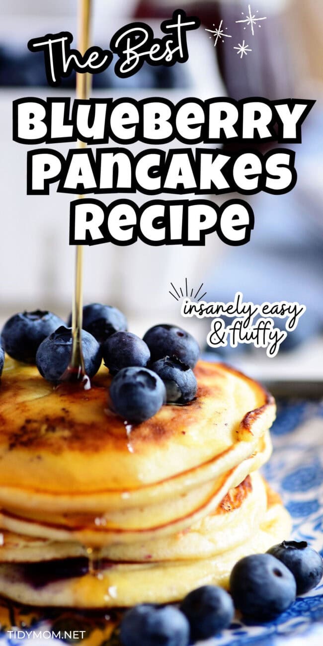 syrup being poured over a stack of blueberry pancakes