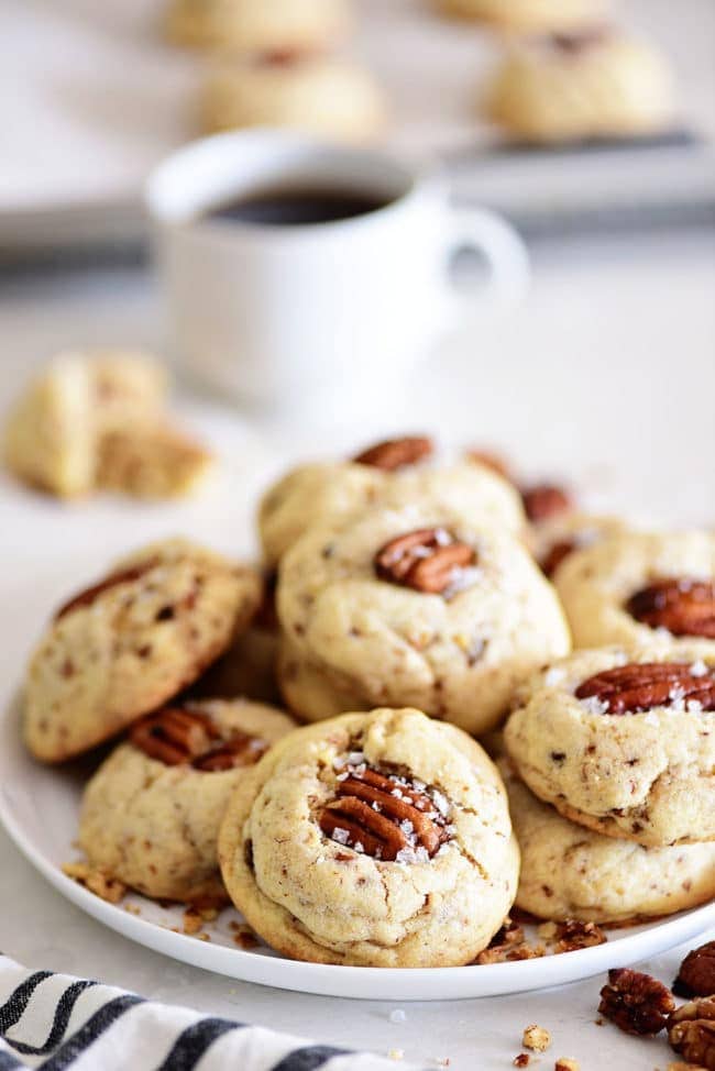 Butter Pecan Cookies on a plate with a cup of coffee