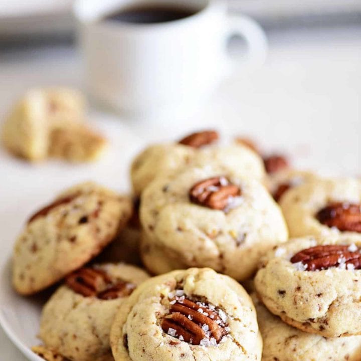 Butter Pecan Cookies on a plate with a cup of coffee