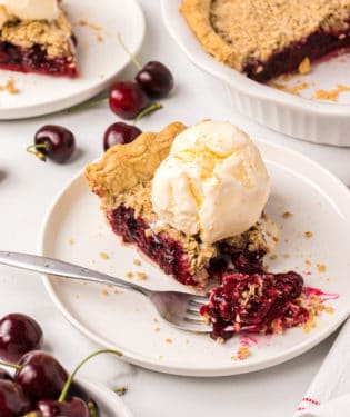 A bite of cherry pie on a fork