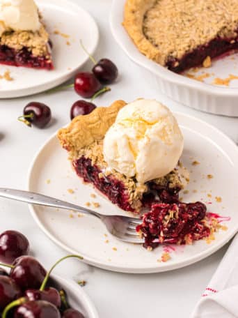 A bite of cherry pie on a fork