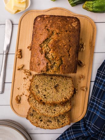 sliced loaf of classic zucchini bread on a wood board