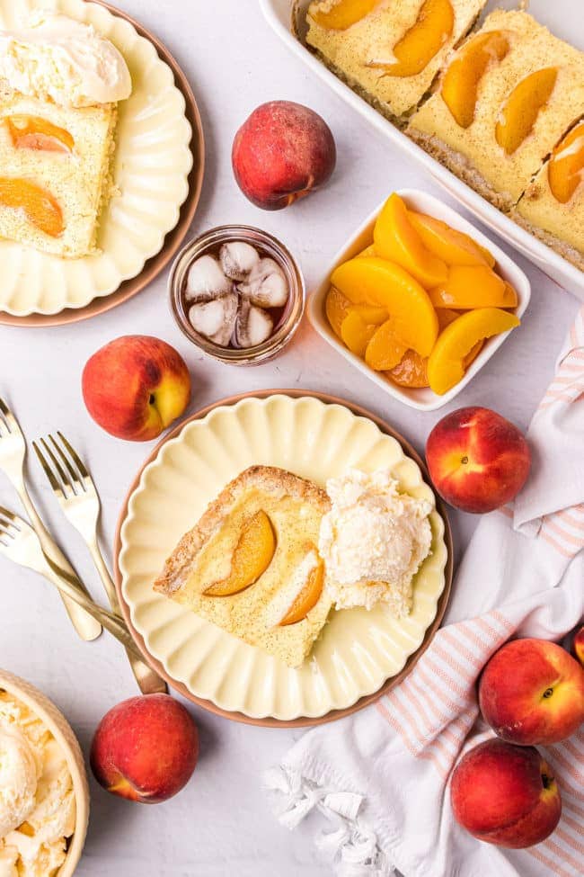 Peach kuchen dessert on plates with fresh peaches