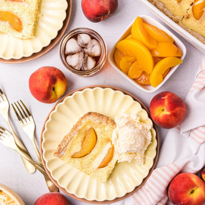 Peach kuchen dessert on plates with fresh peaches