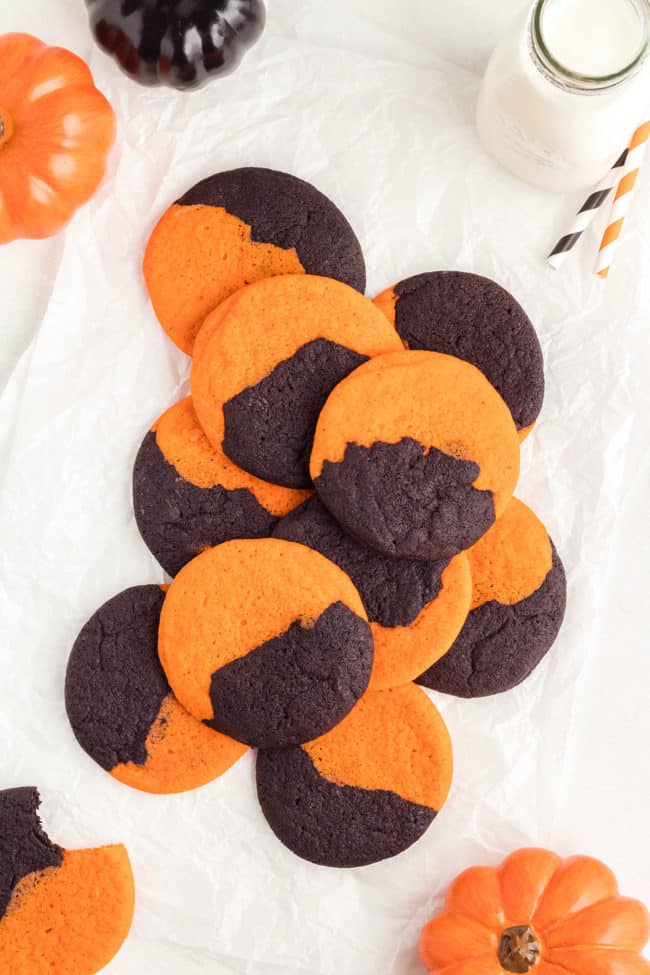 Orange and Black Halloween Cookies spread out on a table