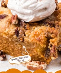 close up of a serving of pumpkin dump cake with whipped cream