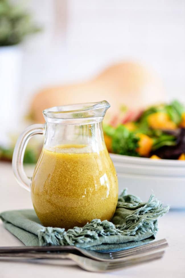 homemade Maple dijon vinaigrette next to a salad