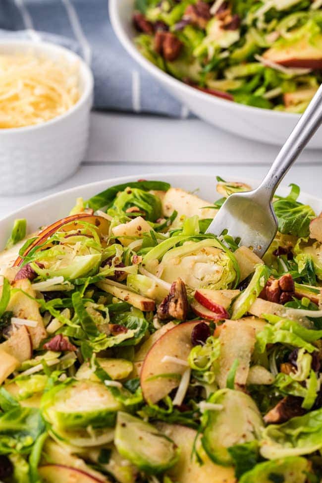 For in a white bowl of Brussels Sprouts Salad with apples