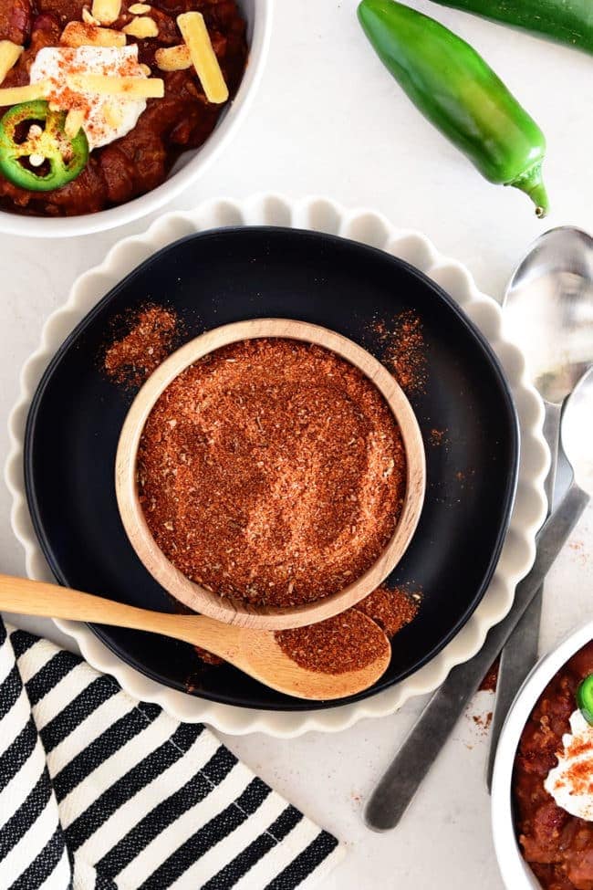 Homemade chili mix in a small wood bowl with wooden spoon