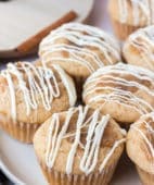 cinnamon roll muffins with white chocolate icing on a plate