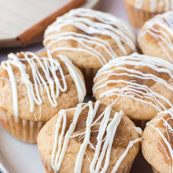 cinnamon roll muffins with white chocolate icing on a plate