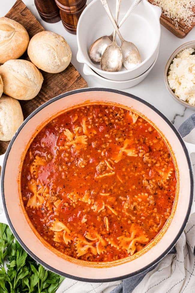 A white pot of homemade lasagna soup with Italian sausage