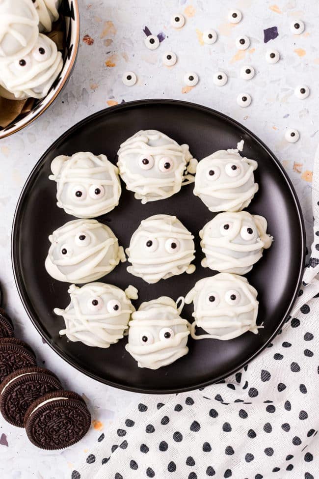 Mummy Oreo Truffles on a black plate for halloween