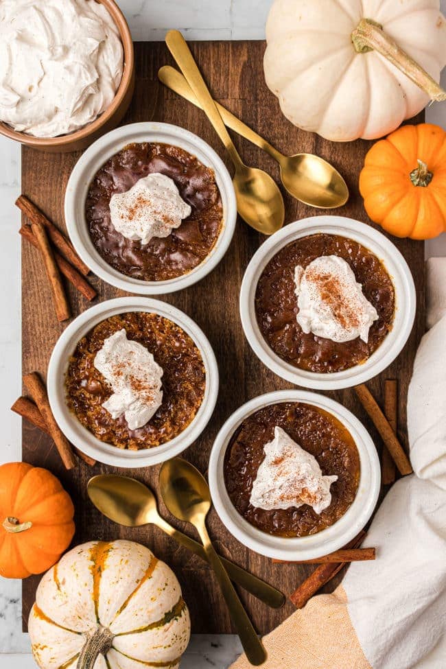 four servings of Pumpkin Crème Brûlée with whipped cream on top