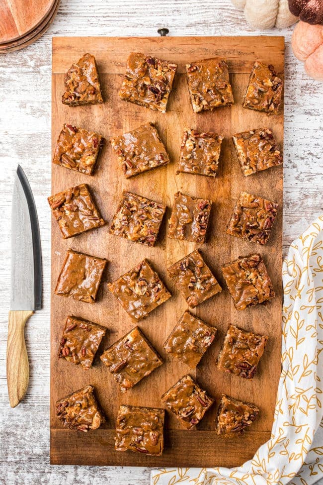 cut Pumpkin Magic Bars on a wood board