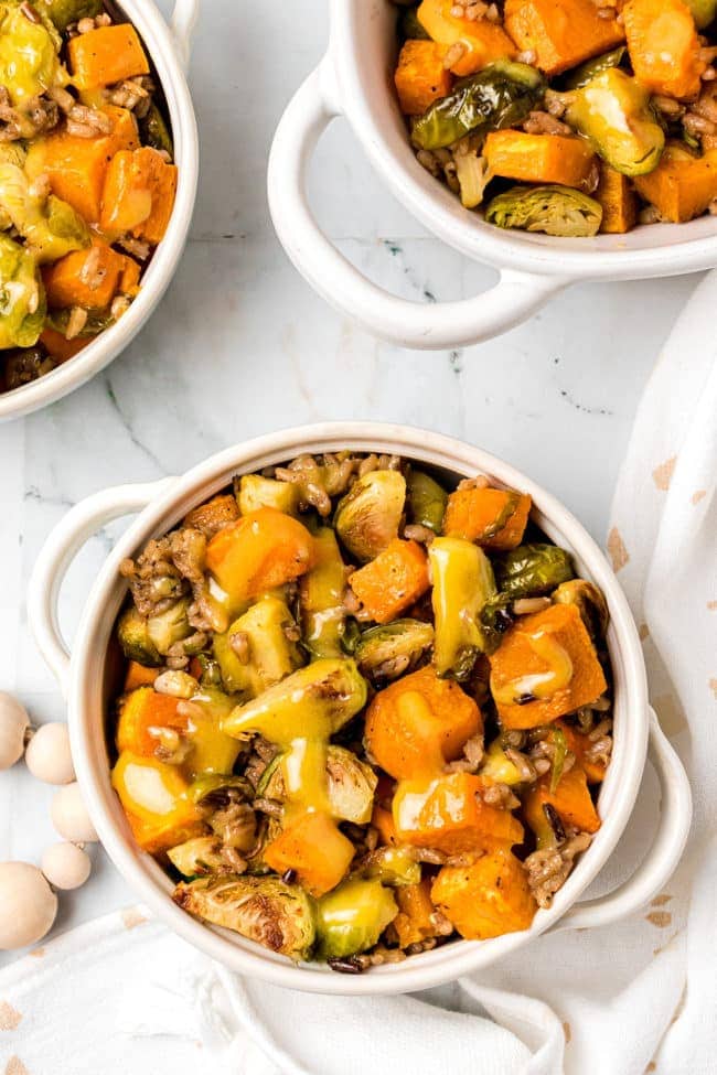 Roasted Brussels Sprouts And Sweet Potatoes in white bowls