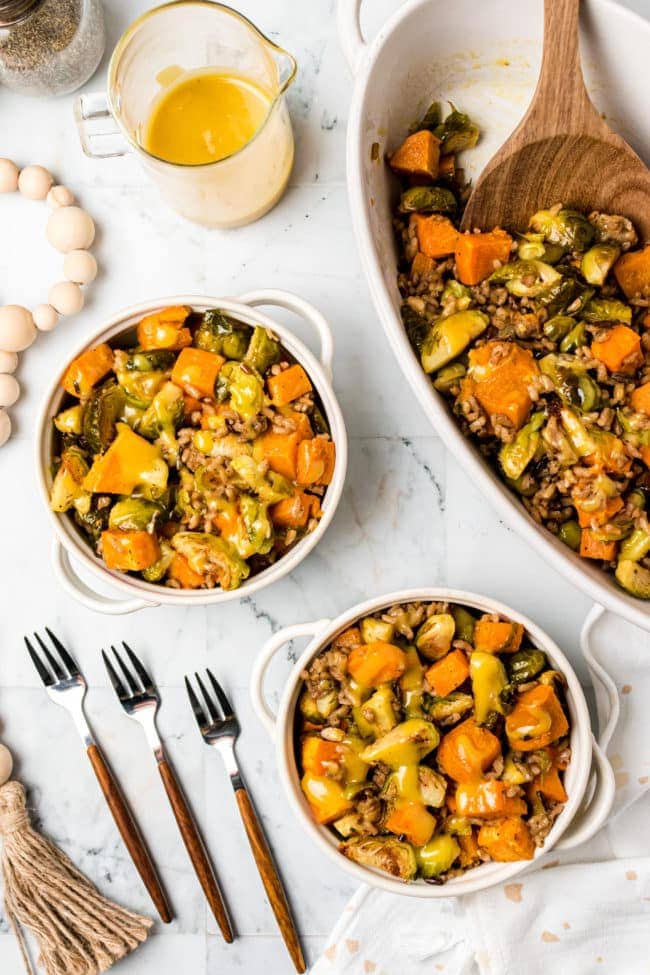 two servings of Roasted Brussels Sprouts And Sweet Potatoes With Wild Rice side dish