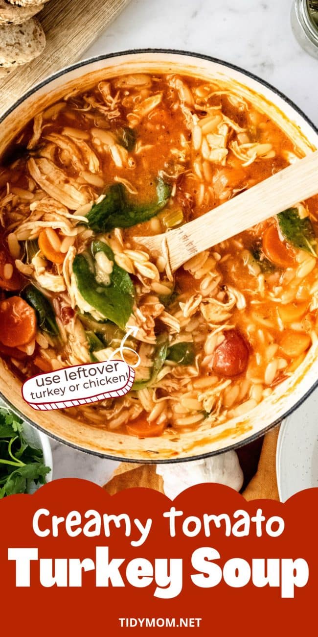 creamy tomato turkey soup with spinach in a dutch oven