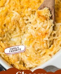 cheesy hashbrown potato casserole in a baking dish with a wooden spoon