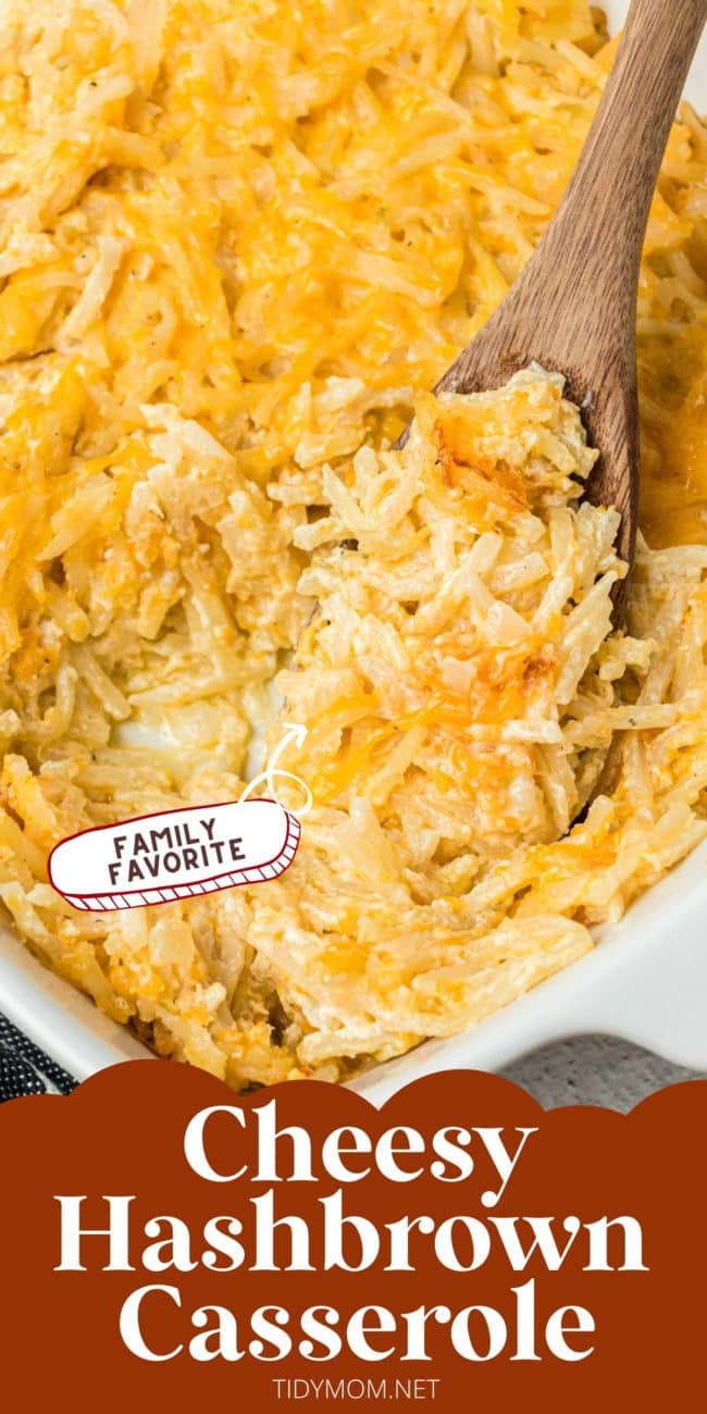 cheesy hashbrown potato casserole in a baking dish with a wooden spoon