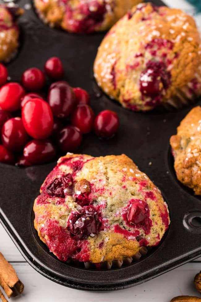 a pan of muffins with cranberries