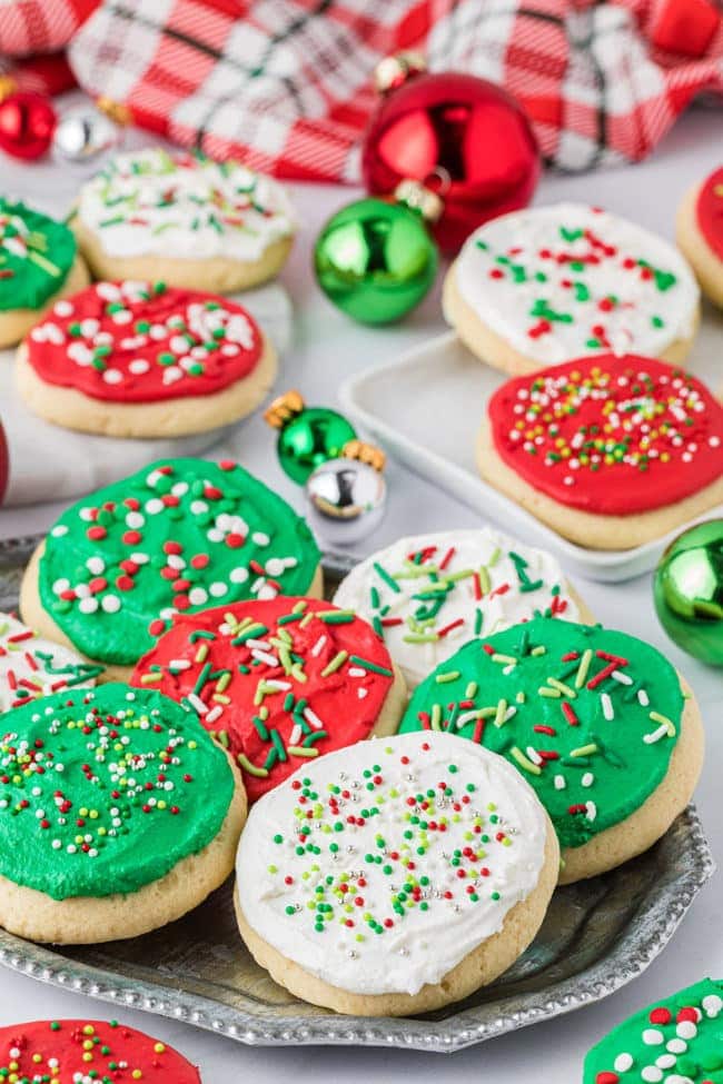 Frosted sugar cookies on a tray on the counter