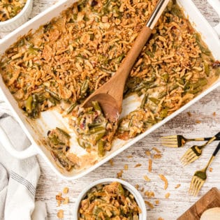 green bean casserole with a wooden spoon to serve