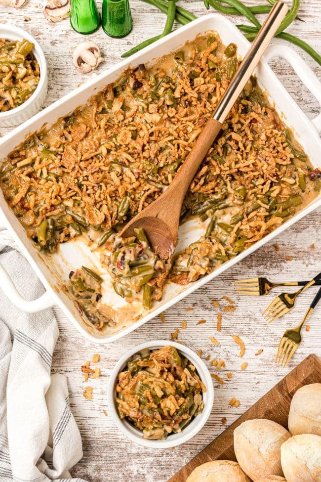 green bean casserole with a wooden spoon to serve