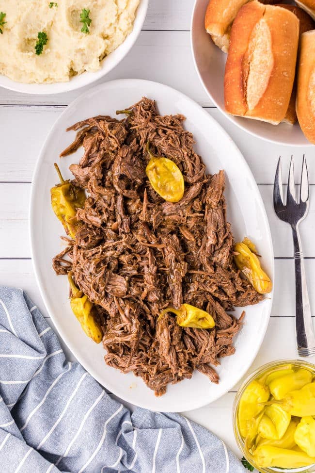 mississippi pot roast on a white patter with pepperoncini