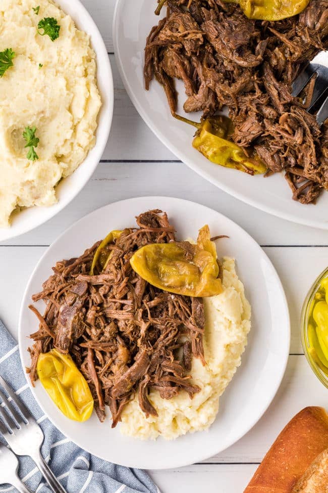 shredded pot roast with mashed potatoes on a plate