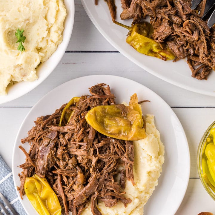 shredded pot roast with mashed potatoes on a plate