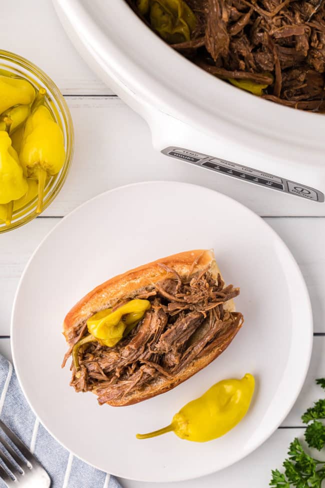 shredded pot roast sandwich on a white plate