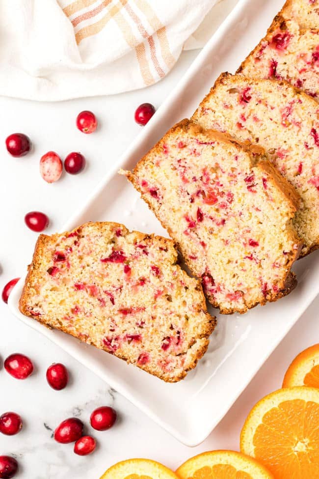 slices of cranberry orange bread on a white platter