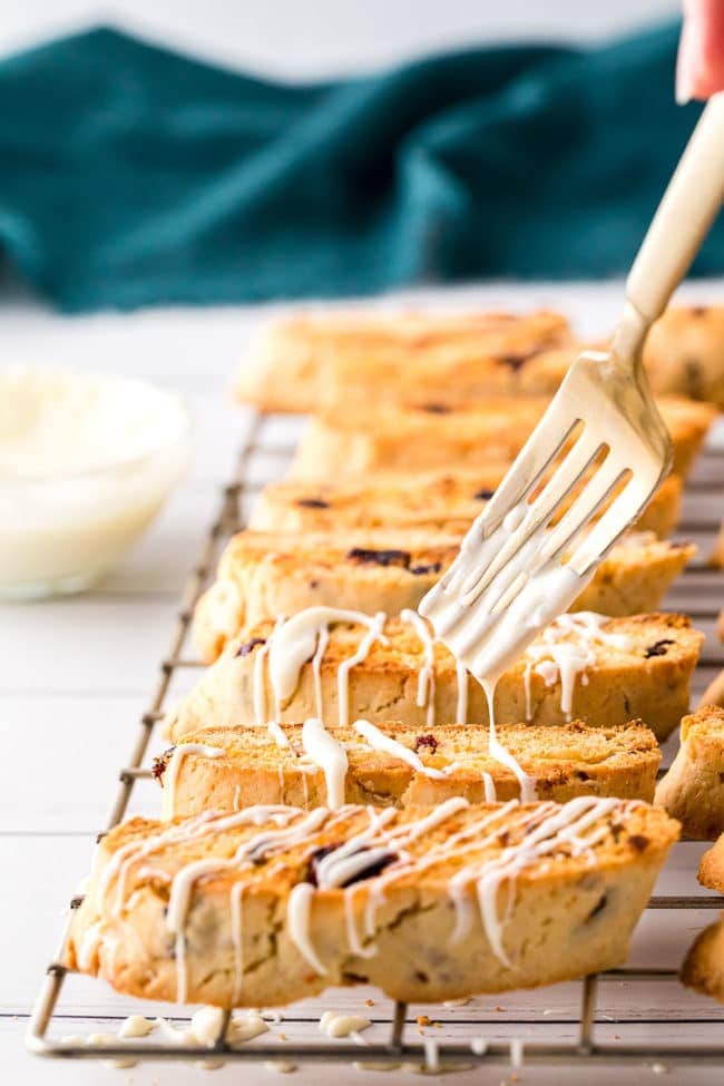 drizzling biscotti with white chocolate using a fork