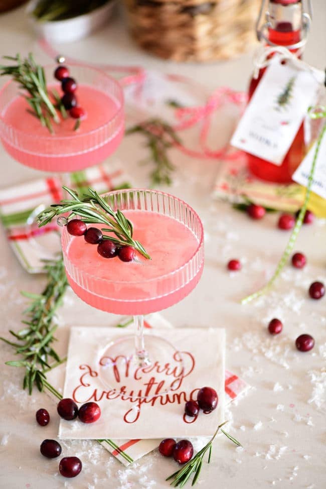 overhead shot of pink cranberry cosmo cocktail on a Merry Everything napkin