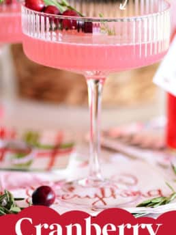 a pink Christmas cocktail in a coupe glass